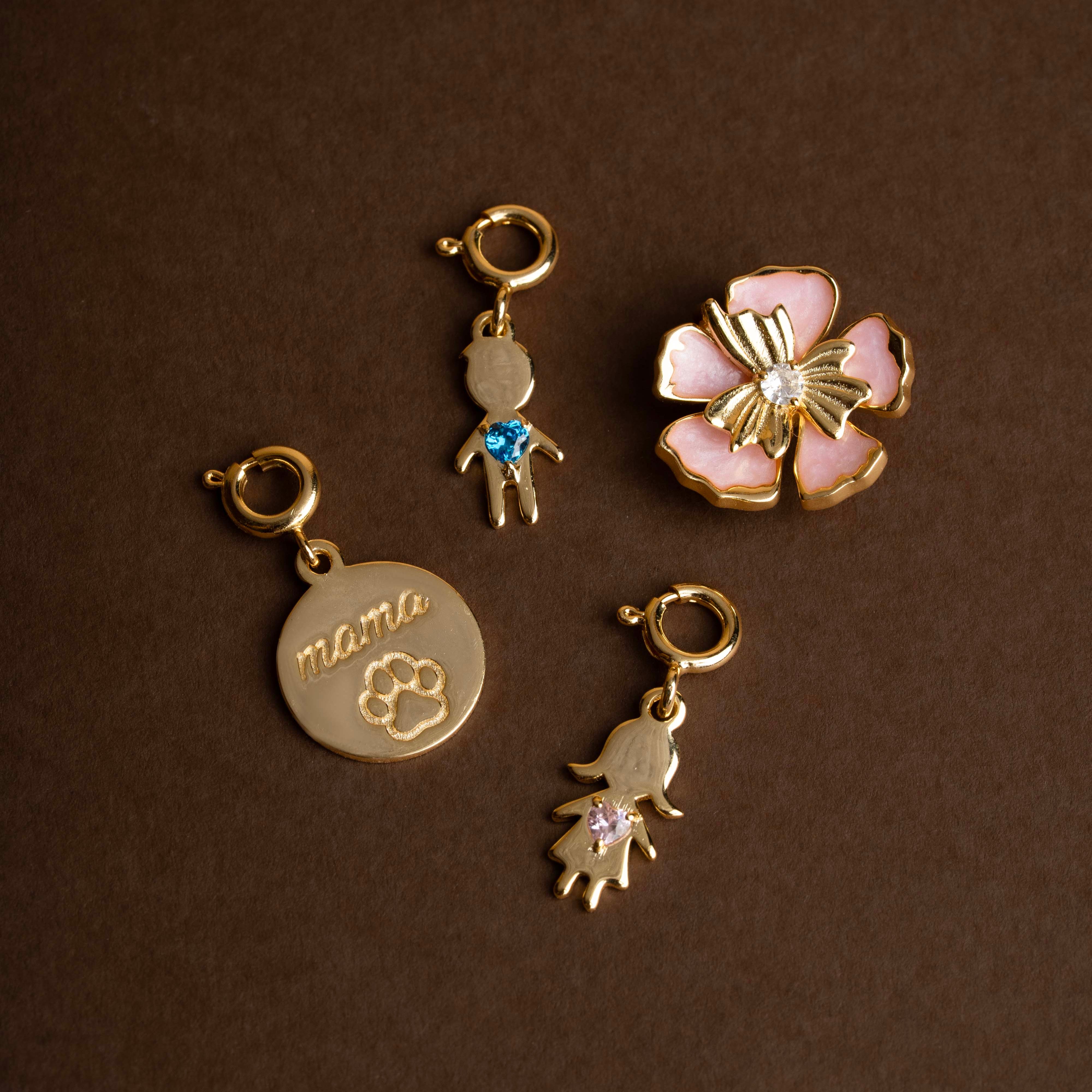 Set of gold charms on a brown background